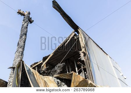 Damaged Roof Industry Supermarket After Arson Fire With Burn Debris Of Twisted Metal Structure After
