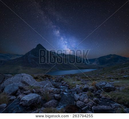 Stunning Vibrant Milky Way Composite Image Over Beautiful Landscape Image Of Stream Near Llyn Ogwen 