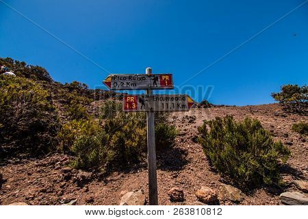 Wooden Road Sigh Pointing Pico Ruivo At The Highest Walking Path Of Madeira Island.