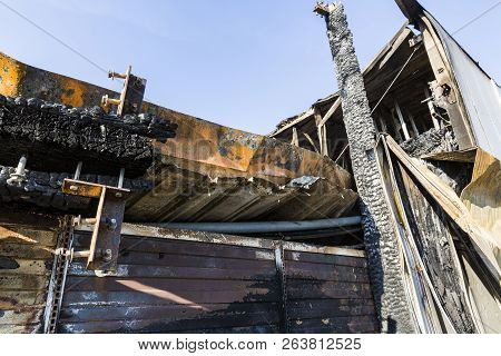 Damaged Industry Supermarket After Arson Fire With Burn Debris Of Twisted Metal Wood Structure After