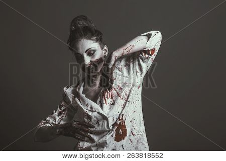 Scary Damaged Girl In Nurce Halloween Costume Looking Like Zombie, Isolated