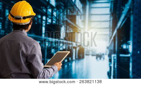 Engineer Manager Wearing Hard Hat Using Tablet Check And Control For Workers With Warehouse Logistic