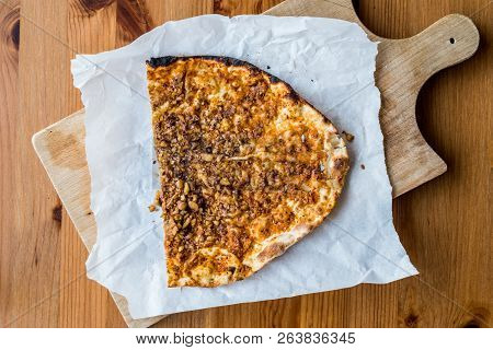 Half Lahmacun With Walnut Or Turkish Pizza Slice On Wooden Surface.