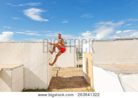 Young Man Practicing Yoga In A Urban Background. Parkour