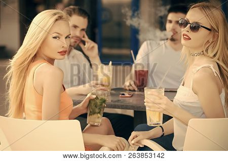 Women Twins And Men Friends Relax In Cafe Outdoor. Man Vapor Hookah Pipe In Shisha Bar Lounge. Celeb