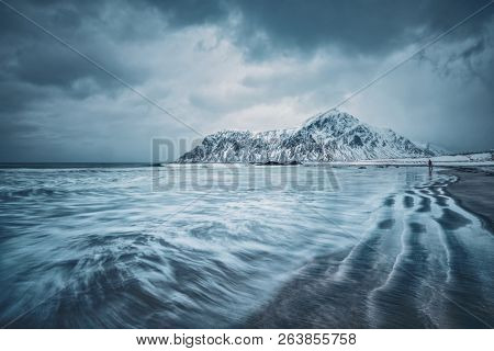 Waves on coast of Norwegian sea in fjord. Skagsanden beach, Flakstad, Lofoten islands, Norway. Long exposure motion blur
