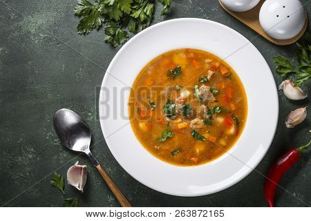 Traditional Hungarian Goulash Soup On The Table. European Cuisine. Top View With Copy Space,