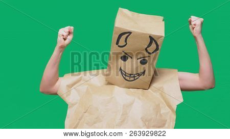 Concept Of Emotion, Gestures. A Man With A Package On His Head, With A Painted Smiley Angry, Sly, Gl