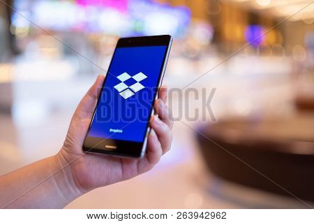 Chiang Mai, Thailand - August 03,2018: Woman Holding Huawei With Dropbox On Screen. Dropbox Is A Ser