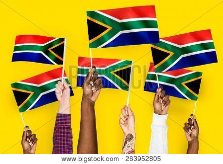 Hands waving flags of South Africa
