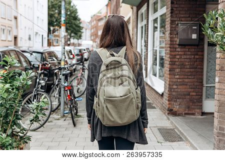 Tourist With A Backpack Is Looking For Booked Online Accommodation In An Unfamiliar City. Or A Stude
