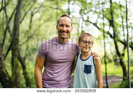 Father Giving His Son A Piggyback Ride, Having Fun