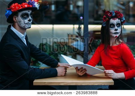 A Couple, Wearing Skull Make-up For. All Souls Day. Boy And Girl Sugar Skull Makeup.painted For Hall
