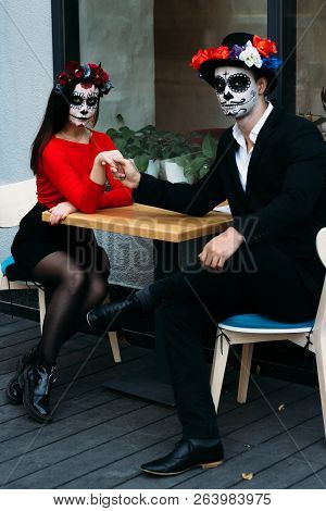A Couple, Wearing Skull Make-up For. All Souls Day. Boy And Girl Sugar Skull Makeup.painted For Hall