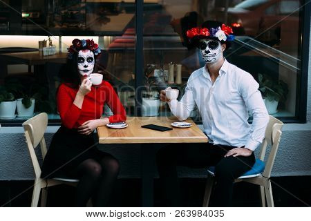 A Couple, Wearing Skull Make-up For. All Souls Day. Boy And Girl Sugar Skull Makeup.painted For Hall