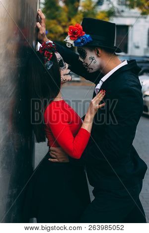 A Couple, Wearing Skull Make-up For. All Souls Day. Boy And Girl Sugar Skull Makeup.painted For Hall