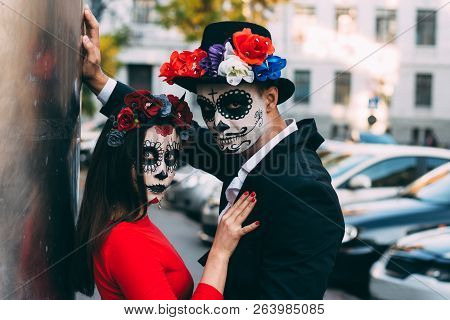 A Couple, Wearing Skull Make-up For. All Souls Day. Boy And Girl Sugar Skull Makeup.painted For Hall