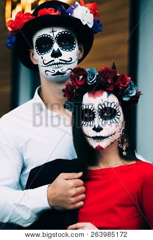 A Couple, Wearing Skull Make-up For. All Souls Day. Boy And Girl Sugar Skull Makeup.painted For Hall
