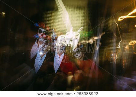 Blur. A Man And A Woman With A Visage, A Pattern Of Skulls, A Zombie On The Face. Dead At Night. A P