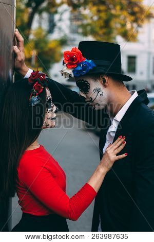 A Couple, Wearing Skull Make-up For. All Souls Day. Boy And Girl Sugar Skull Makeup.painted For Hall