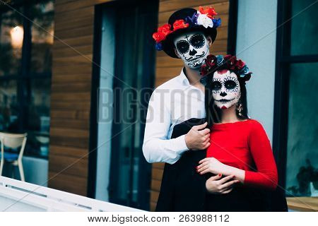 A Couple, Wearing Skull Make-up For. All Souls Day. Boy And Girl Sugar Skull Makeup.painted For Hall