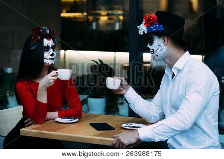 A Couple, Wearing Skull Make-up For. All Souls Day. Boy And Girl Sugar Skull Makeup.painted For Hall