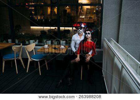 A Couple, Wearing Skull Make-up For. All Souls Day. Boy And Girl Sugar Skull Makeup.painted For Hall