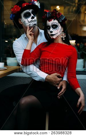 A Couple, Wearing Skull Make-up For. All Souls Day. Boy And Girl Sugar Skull Makeup.painted For Hall