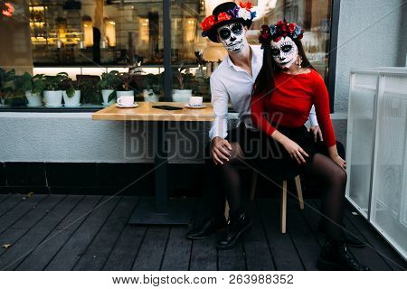 A Couple, Wearing Skull Make-up For. All Souls Day. Boy And Girl Sugar Skull Makeup.painted For Hall