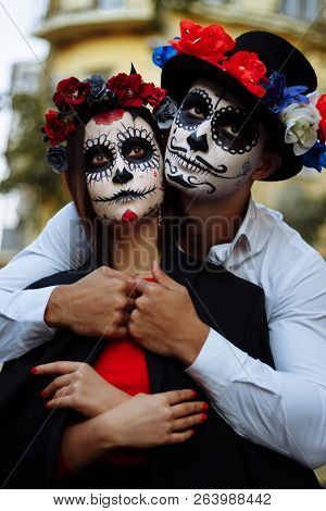 A Couple, Wearing Skull Make-up For. All Souls Day. Boy And Girl Sugar Skull Makeup.painted For Hall