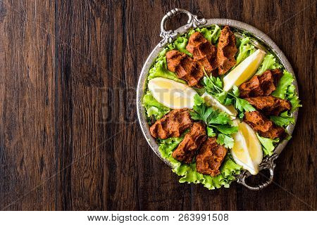 Turkish Food Cig Kofte With Lemon, Lettuce And Parsley On Silver Tray.