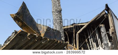Damaged Roof Industry Supermarket After Arson Fire With Burn Debris Of Twisted Metal Structure After