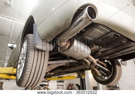 Close Up Of Car Exhaust System Pipe At The Garage, Automotive Car Service