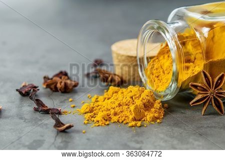Heap Of Turmeric Powder, Anise Stars And Dry Turmeric Flowers Closeup. Immunomodulators, Healthy Con