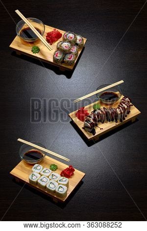 Tasty And Delicious Hot And Cold Sushi Rolls On The Table. Different Sushi - Rolls With Sauce On The