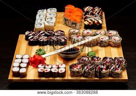 Tasty And Delicious Hot And Cold Sushi Rolls On The Table. Different Sushi - Rolls With Sauce On The