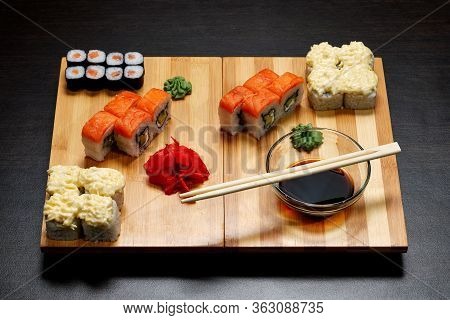 Tasty And Delicious Hot And Cold Sushi Rolls On The Table. Different Sushi - Rolls With Sauce On The