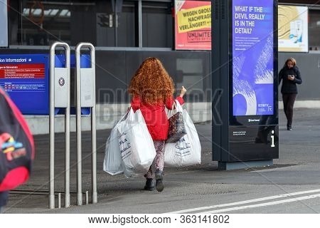 Zuerich, Switzerland - November 9, 2019. Young Red-haired Woman Carrying Many Shopping Bags After A 