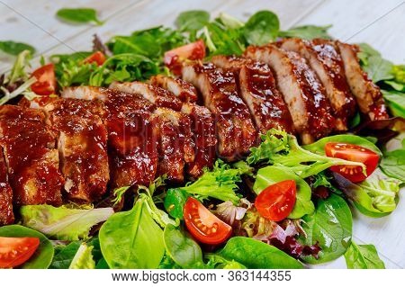 Baked Spare Baby Back Ribs With Green Salad And Tomato.