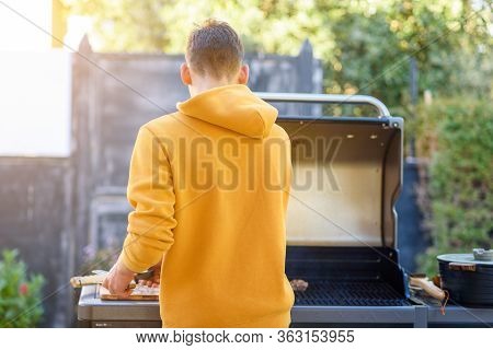 Backyard Bbq In Independence Day, Yom Haatzmaut. Happy Young Man Having A Barbecue In The Yard Of A 