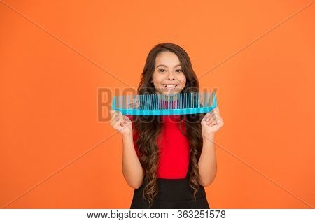 Say Goodbye To Knots And Tangles. Happy Child Hold Comb Brown Background. Hair Combing. Combing Befo