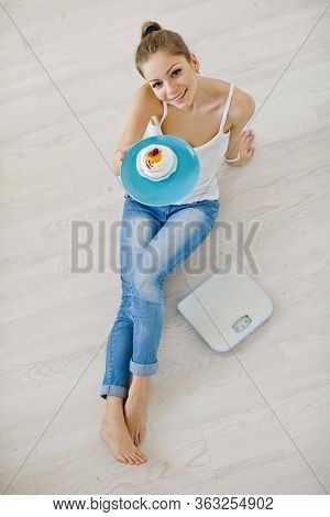 Young Woman On A Diet. Girl With Weights.