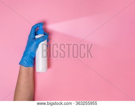Coronavirus Protection. Hand In Blue Disposable Glove Overspraying Surface Disinfectant Or Hand Sani