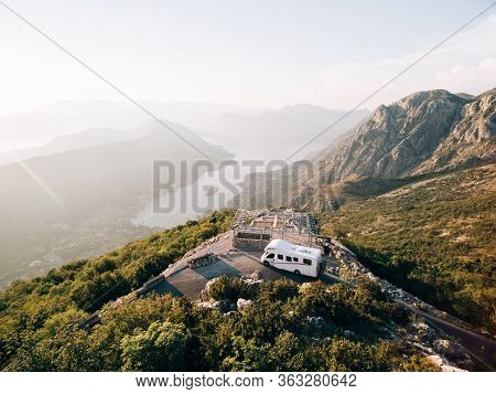 Caravan At The Top Of Mount Lovchen In Montenegro. A House On Wheels Near A Mountain Cliff. Trailer 