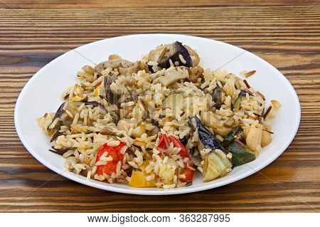 Stewed Vegetables With Rice On A Plate On A Wooden Background