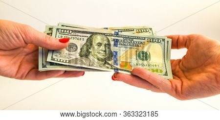 Transfer Of Money, Hand With Banknotes 100 Dollar, Usd Notes As Background The United States Dollar 