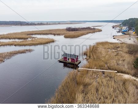 Beautiful Riverside Areal View Of River Lielupe Flowing Near Pine Forest Strees On Both Coast Lines.