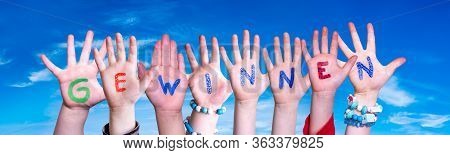 Children Hands Building Word Gewinnen Means Win, Blue Sky