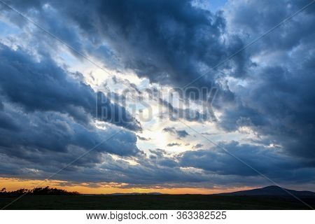 Stormy Sky With Storm Clouns On The Sunset With Beautiful Sun