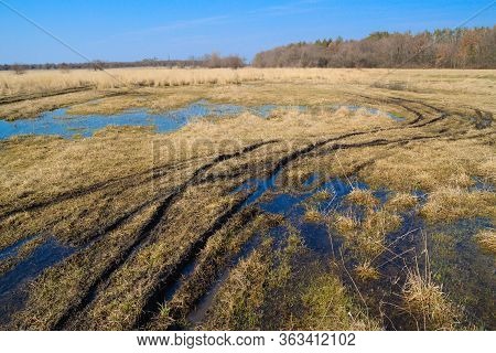 Landscape Flooded Meadows In Early Spring. White Clouds Reflected In Puddles Of Water. Beautiful Ste